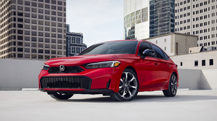 Red Honda sedan parked against a city skyline, showcasing modern design and features, relevant to Honda collision repair services in Miami.