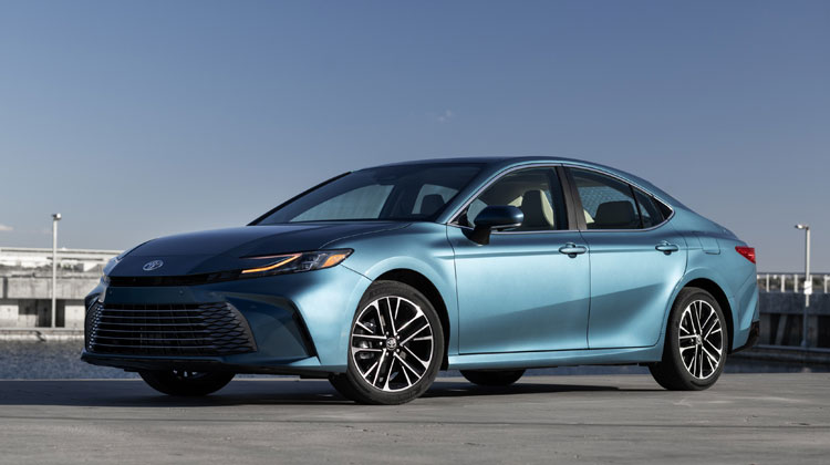 Toyota Camry in blue color parked near water, showcasing sleek design and modern features, representing high-quality collision repair services at Tropical Collision Center in Miami, FL.